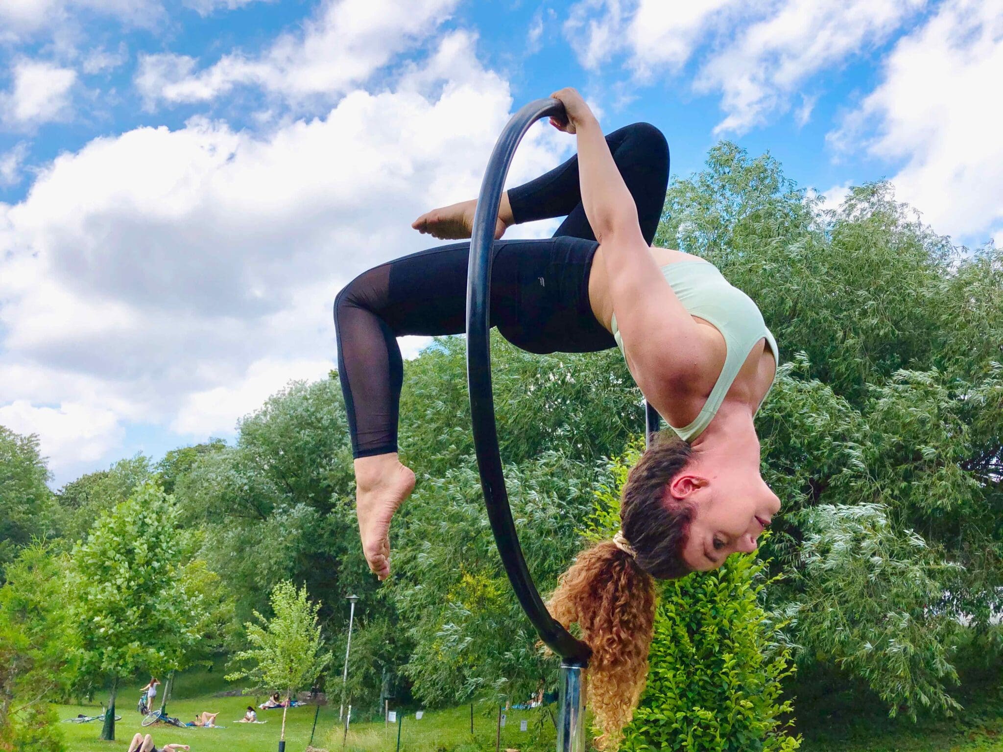 Cassandra wearing the V Shred Seamless Flex Sports Bra during an outdoor aerial hoop training session