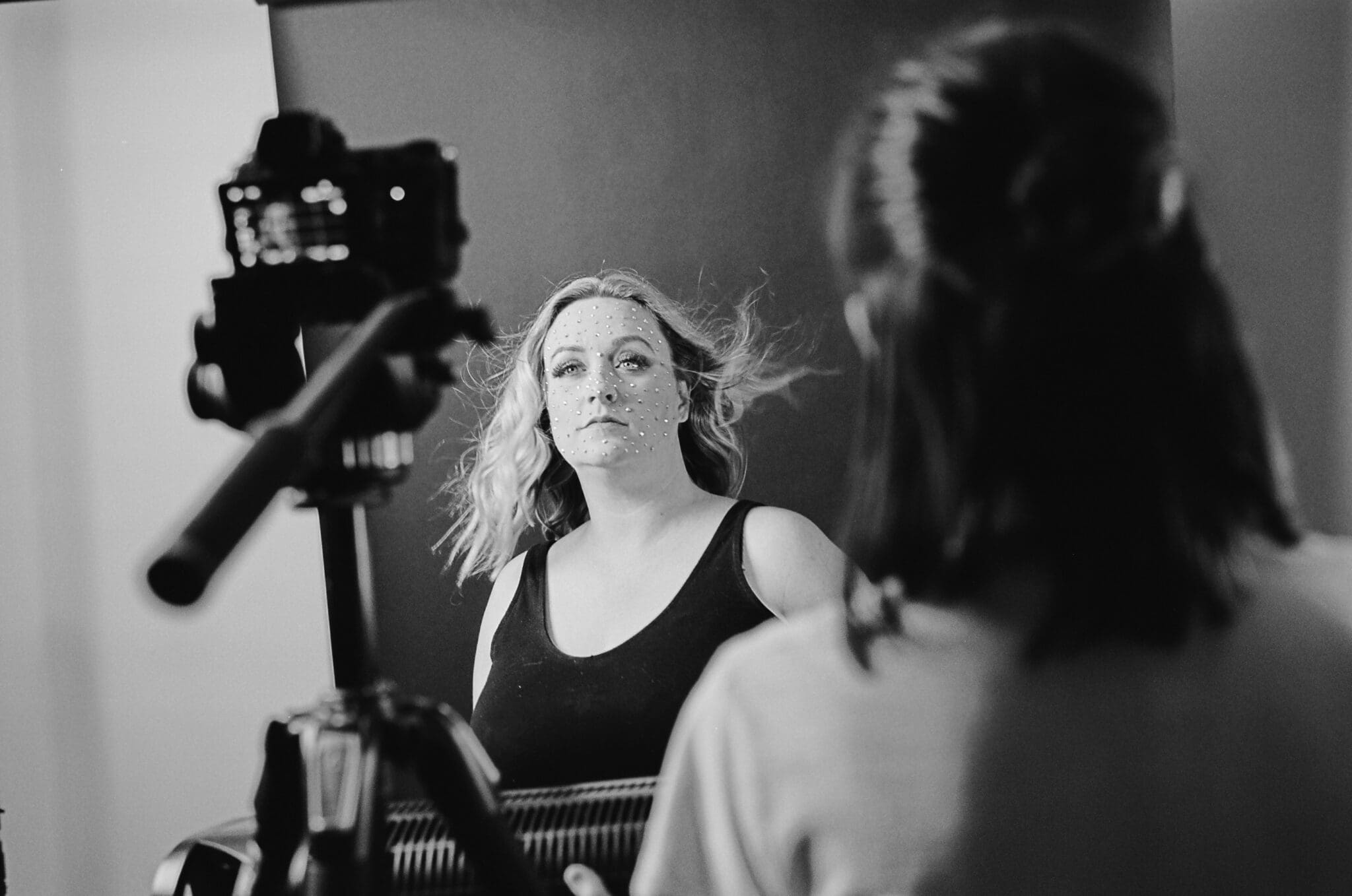 farideh on set of her music video for Otherside of Truth. Her face is covered in Swarovski crystals. The photo is black and white.