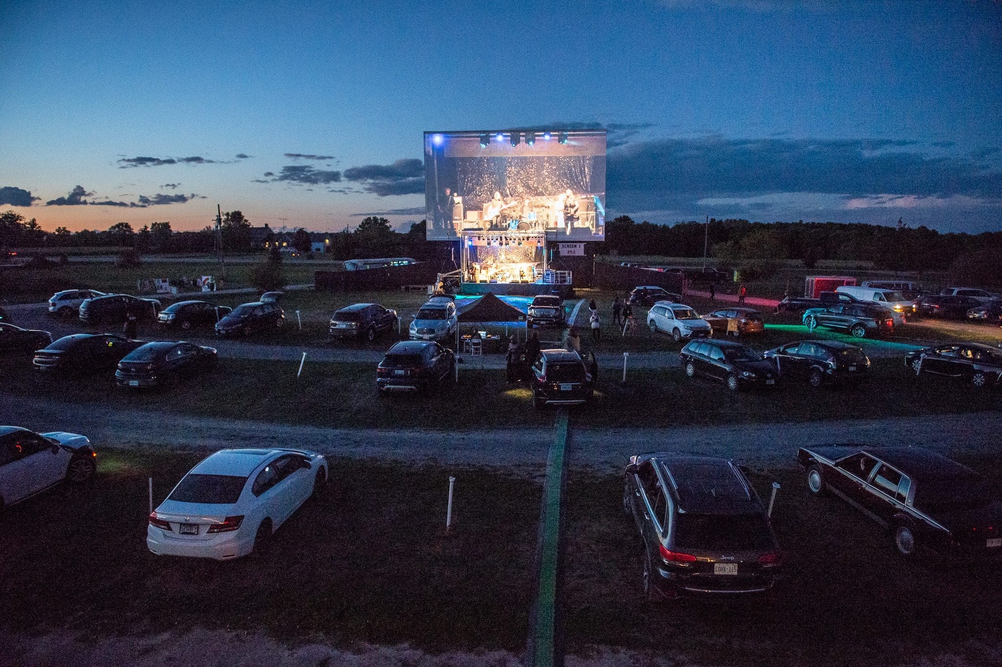 Golden Hour Festival is back with iskwē, Tom Wilson, Donovan Woods and the Opposition, and William Prince Photo of Golden Hour Festival cars lined up at the drive in watching a concert