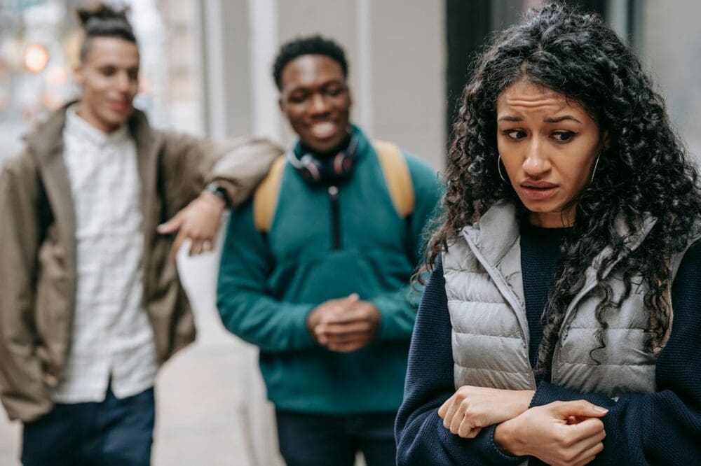A concerned girl standing near two boys