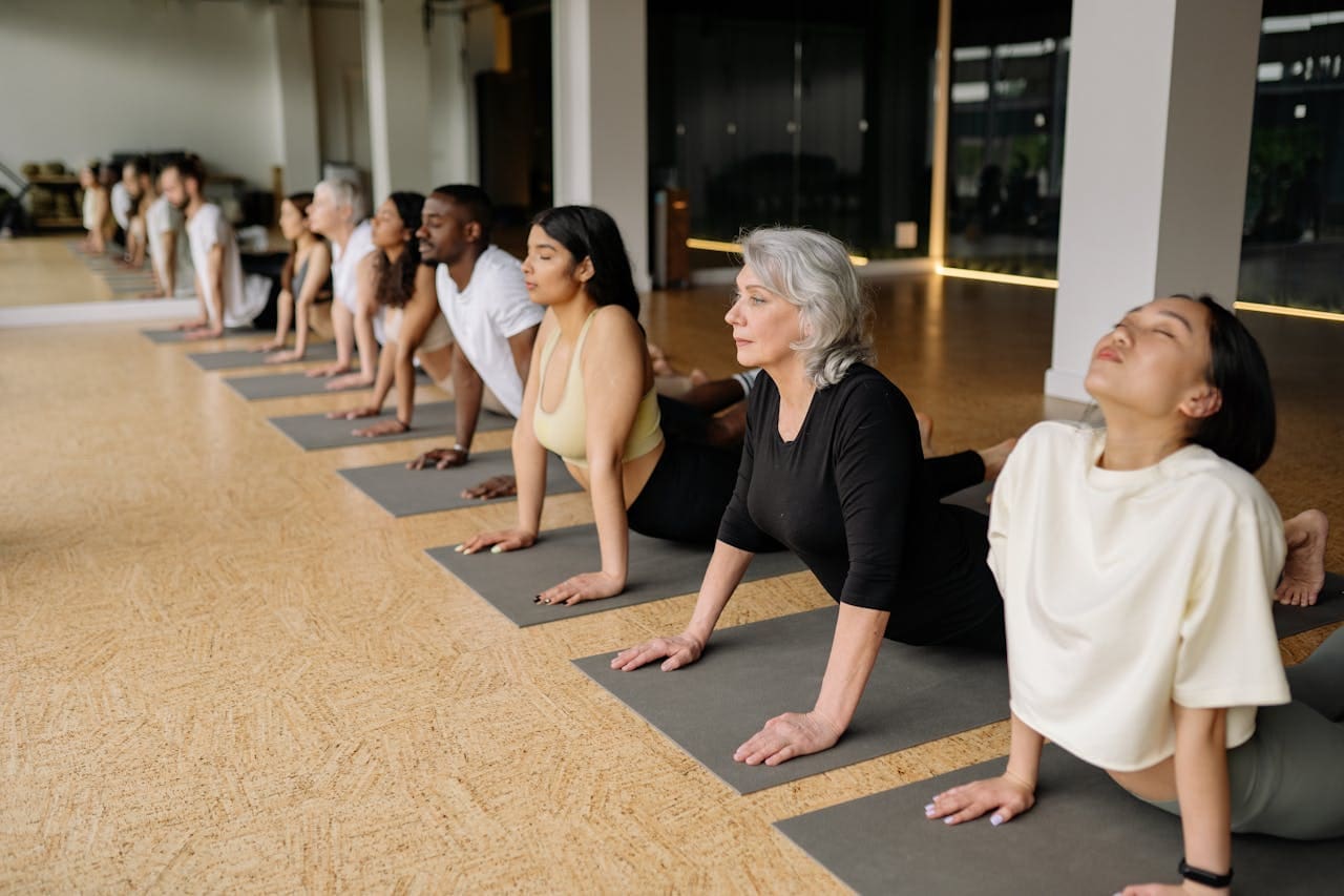 Small Habits, Big Impact: Everyday Rituals to Boost Your Mental Wellbeing people doing yoga in a studio